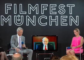 Strategic investors. Dr. Stephan Goetz, Warren Buffett (on video link) and Baronin Ariane de Rothschild at the Munich Film Festival,2012 (Source: Wikimedia Commons) Strategic investors. Dr. Stephan Goetz, Warren Buffett (on video link) and Baronin Ariane de Rothschild at the Munich Film Festival,2012 (Source: Wikimedia Commons)