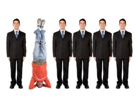 Business people in a series with a casual guy doing the headstand Business people in a series with a casual guy doing the headstand